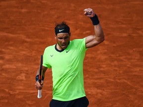 TOPSHOT - Spain's Rafael Nadal celebrates after winning against Britain's Cameron Norrie during their men's singles third round tennis match on Day 7 of The Roland Garros 2021 French Open tennis tournament in Paris.