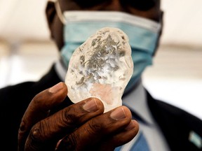 Botswana President Mokgweetsi Masisi holds a gem diamond in Gaborone, Botswana, on June 16.