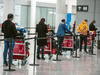 International travellers await transportation to a COVID-19 quarantine hotel after arriving at Pearson International Airport, February 24, 2021.