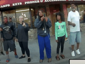 Darnella Frazier, ventre, uses her cellphone to record the arrest of George Floyd, in an image taken from Minneapolis Police body camera video in Minneapolis, Minnesota, May 25, 2020.