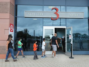 People line up to receive a vaccine at the Canadian Tire Centre in Ottawa in late June.