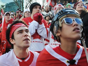 Canadian fans watch the Winter Olympic Men's Ice Hockey final in Vancouver on February 28, 2010.