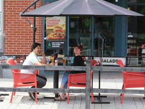 File: Patios are open, with precautions in place.