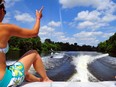 L-R Mila Roy (volleyball instructor) Angie Whiting (on the wakeboard) and Laurie Andrews take a session down the river to learn how to Wakeboard.