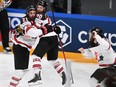 Canada's forward Nick Paul (C) celebrates scoring the winning 3-2 goal with team mate Canada's defender Troy Stecher (C) during the IIHF Men's Ice Hockey World Championships final match between the Finland and Canada at the Arena Riga in Riga, Latvia, on June 5, 2021.