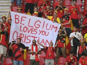TOPSHOT - Belgium fans with a banner with a message of support for Denmark's midfielder Christian Eriksen wait for the start of the UEFA EURO 2020 Group B football match between Denmark and Belgium at the Parken Stadium in Copenhagen on June 17, 2021. - Eriksen suffered a cardiac arrest during his country's Euro 2020 opener last weekend.