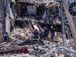 Files: Search and Rescue teams look for possible survivors in the partially collapsed 12-story Champlain Towers South condo building on June 27, 2021 in Surfside, Florida. -