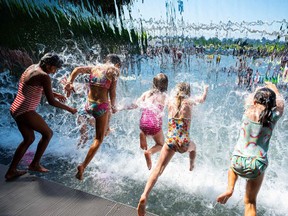 FILE: Kids splash through a waterfall.