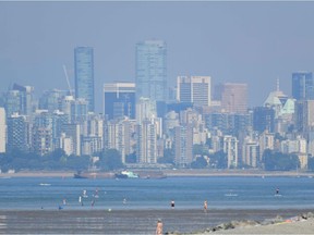 The city of Vancouver, British Columbia, is seen through a haze on a scorching hot day, June 29, 2021. - Schools and Covid-19 vaccination centers closed Monday while community cooling centers opened .