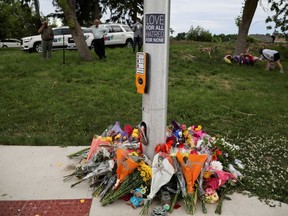 Flowers lay in memorial at the fatal crime scene where a man driving a pickup truck jumped the curb and ran over a Muslim family in what police say was a deliberately targeted anti-Islamic hate crime, in London, Ontario.