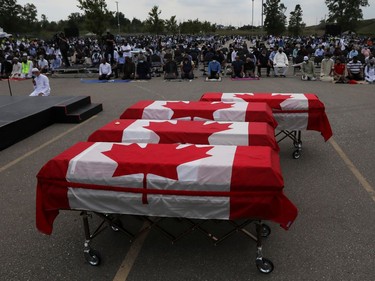 Flag-wrapped coffins are seen outside the Islamic Centre of Southwest Ontario, during a funeral of the Afzaal family that was killed in what police describe as a hate-motivated attack, in London, Ontario, Canada June 12, 2021. REUTERS/Carlos Osorio ORG XMIT: GDN