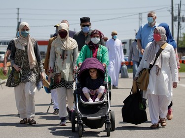 People arrive at a funeral of the Afzaal family that was killed in what police describe as a hate-motivated attack, outside the Islamic Centre of Southwest Ontario, in London, Ontario, Canada June 12, 2021. REUTERS/Carlos Osorio ORG XMIT: GDN