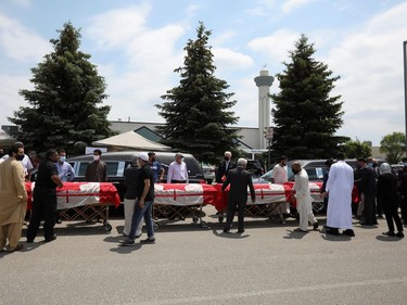 Flag-wrapped coffins are seen outside the Islamic Centre of Southwest Ontario, during a funeral of the Afzaal family that was killed in what police describe as a hate-motivated attack, in London, Ontario, Canada June 12, 2021. REUTERS/Carlos Osorio ORG XMIT: GDN