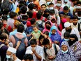 People board an overcrowded ferry as they go home a day before a countrywide lockdown is imposed, in Munshiganj, outskirts of Dhaka, Bangladesh, June 30, 2021.