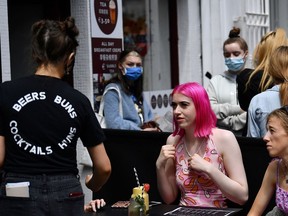 FILE PHOTO: People enjoy outdoor dining as outdoor services in restaurants and bars recommences in Ireland as restrictions ease following the coronavirus disease (COVID-19) outbreak, in Galway, Ireland, June 7, 2021.
