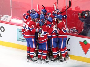 Montreal Canadiens players celebrate their win against Vegas Golden Knights during an over time period in game three of the 2021 Stanley Cup Semifinals at Bell Centre.