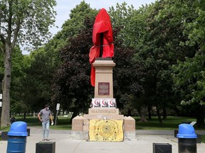 The statue of Canada's first prime minister, Sir John A. Macdonald, is shrouded at City Park in Kingston on Friday, June 11.