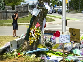 A man visits a memorial to the victims of the deadly vehicle attack on five members of the Canadian Muslim community in London, Ont., on Monday, June 14, 2021.