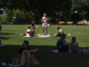 FILE: People enjoy the warm weather at Major's Hill Park in Ottawa.