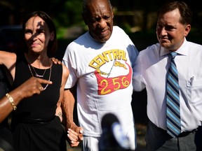 Bill Cosby is welcomed outside his home after Pennsylvania's highest court overturned his sexual assault conviction and ordered him released from prison immediately, in Elkins Park, Pennsylvania, U.S., June 30, 2021.  At left is lawyer Jennifer Bonjean.