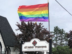 A rainbow Pride flag flies outside All Saints Anglican Church in Petawawa.