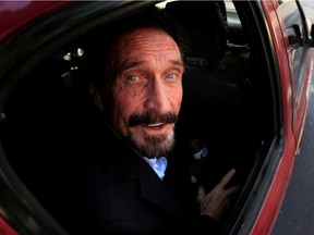 FILE PHOTO: Software pioneer John McAfee is escorted by immigration officers to the Guatemalan Airport in Guatemala City December 12, 2012