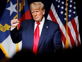 Former U.S. President Donald Trump makes a fist while reacting to applause after speaking at the North Carolina GOP convention dinner in Greenville, North Carolina, U.S. June 5, 2021.
