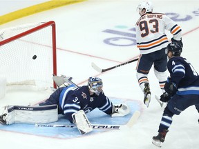 Edmonton Oilers centre Ryan Nugent-Hopkins beats Winnipeg Jets goaltender Connor Hellebuyck during Game 4 of a Stanley Cup playoff series in Winnipeg on Mon., May 24, 2021.
