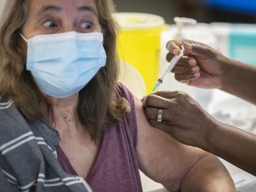 Rolande Fontaine receives the first dose of Moderna's COVID-19 vaccine at the Manoir Aimé-Léonard residence on Thursday March 11, 2021