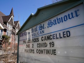 A sign announces that all services have been cancelled due to COVID-19 at St. Saviour's Anglican Church in Toronto on March 15.