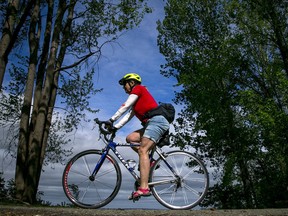File photo/ A cyclist enjoys a ride along the  Ottawa River in the Britannia area.