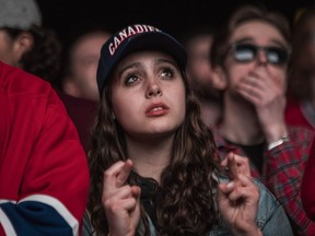 A Canadiens fan crosses her fingers while watching Game 6 of Stanley Cup final at Montreal’s Quartier des spectacles. The Tampa Bay Lightning won the game 6-3 to take 1 3-0 lead in best-of-seven series.