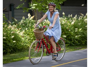 Ottawa Centre MP Catherine McKenna, arrives on her bicycle at the press conference where she announced that she will not be running in the next election.