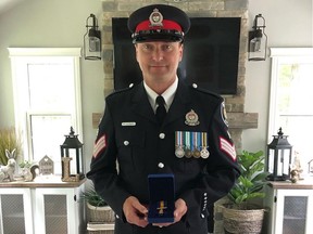 Roy Lalonde showing his Officer of the Order of Merit of the Police Forces medal.