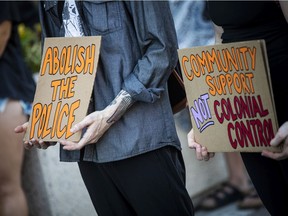 A group of protesters call for defunding, disarming and the eventual dismantling of the police system in front of the Prime Minister’s Office in June, 2021.