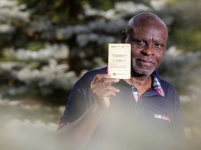 Mohammed Adam holds a vaccine certificate that is often used when travelling internationally.