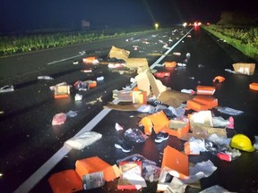 Nike products are strewn over Highway 401 after two big rigs collided early Saturday. There were no injuries.