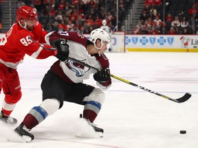 Ryan Graves of the Colorado Avalanche tries to turn away from the stick of Sam Gagner of the Detroit Red Wings during the third period at Little Caesars Arena on March 02, 2020 in Detroit, Michigan.