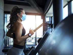 FILE: A woman trains on treadmill in a gym.