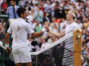 Novak Djokovic of Serbia and Denis Shapovalov of Canada shake hands at the net after their Men's Singles Semi-Final match during Day Eleven of The Championships - Wimbledon 2021 on July 09, 2021.