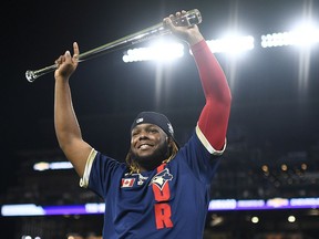 Vladimir Guerrero Jr. #27 of the Toronto Blue Jays celebrates after being awarded the MVP during the 91st MLB All-Star Game at Coors Field on July 13, 2021 in Denver, Colorado. The American League defeated the National League 5-2.