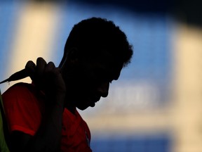 Felix Auger-Aliassime of Team Canada leaves the court after defeat in his Men's Singles First Round match against Max Purcell of Australia on day two of the Tokyo 2020 Olympic Games at Ariake Tennis Park.