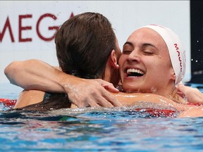 Kaylee McKeown of Team Australia is congratulated by Kylie Masse of Team Canada after winning the gold medal in the Women's 100m Backstroke Final on day four of the Tokyo 2020 Olympic Games at Tokyo Aquatics Centre on July 27, 2021 in Tokyo, Japan.