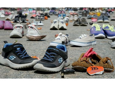 Hundreds of little shoes represent the original 215 children found buried at a residential school site in British Columbia.