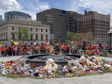 Stuffed children's toys and other items were arranged around the Centennial Flame on Parliament Hill on Thursday.