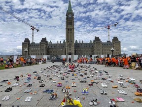 Thursday's event attracted thousands to Parliament Hill, where shoes placed in front of the Centre Block represented victims of Canada's residential school system.