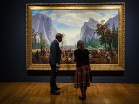 Jonathan Shaughnessy, Director of Curatorial Initiatives, National Gallery of Canada (L) and journalist Lynn Saxberg view The Triumph of Mischief, 2007, by Cree artist Kent Monkman which is part of the Rembrandt in Amsterdam exhibit. Thursday, Jul. 15, 2021.