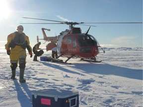 2015 file photo: A group of scientists are loading in a Canadian coast guard helicopter ice samples collected on the sea ice, off the coasts of Devon Islands, in the Canadian High Arctic,