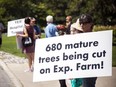 A group of approximately 100 people gathered at the The Man With Two Hats statue by Dow's Lake to protest the land transfer for The Ottawa Hospital project, Sunday, July 4, 2021.