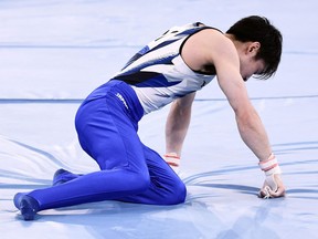 Japan's Kohei Uchimura reacts after falling down during the horizontal bars event of the artistic gymnastics men's qualification during the Tokyo 2020 Olympic Games.